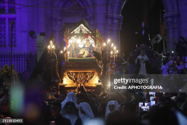 Catholic devotees carry the figure of Jesus Christ in an urn in the Holy Burial Procession in the "El Calvario" Church, in the historic center during...