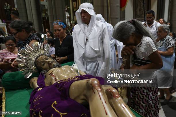 Catholic devotees pray before the image of Jesus Christ in the Holy Burial Procession in the "El Calvario" Church, in the historic center during the...