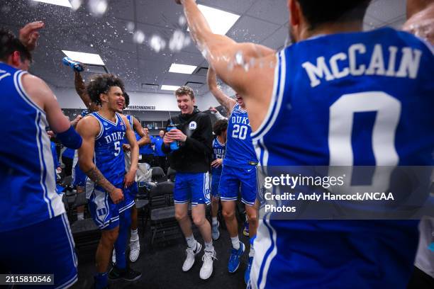 Duke Blue Devils players celebrate in the locker room after defeating the Houston Cougars during the Sweet Sixteen round of the 2024 NCAA Men's...