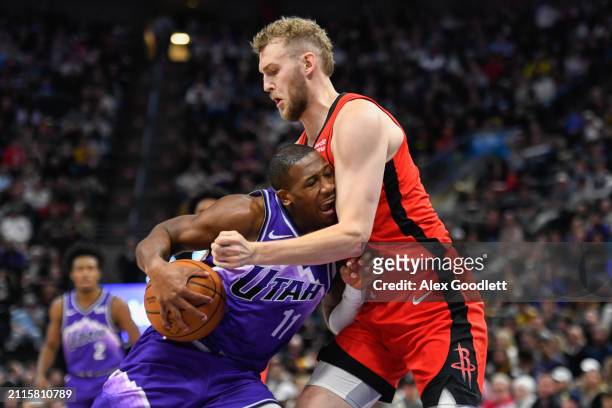 Kris Dunn of the Utah Jazz drives into Jock Landale of the Houston Rockets during the second half of a game at Delta Center on March 29, 2024 in Salt...