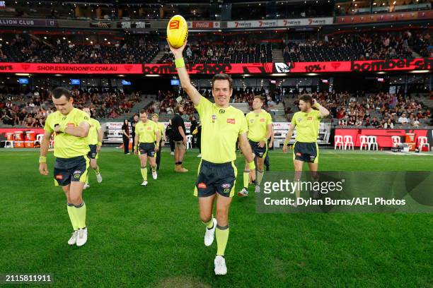 Field Umpire, Robert O'Gorman enters the field in his 200th game during the 2024 AFL Round 03 match between the Essendon Bombers and the St Kilda...