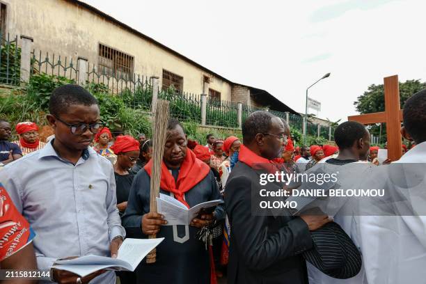 Catholic Christian read scriptures in the street during the procession of the Stations of the Cross, which recalls the last stage of the journey that...