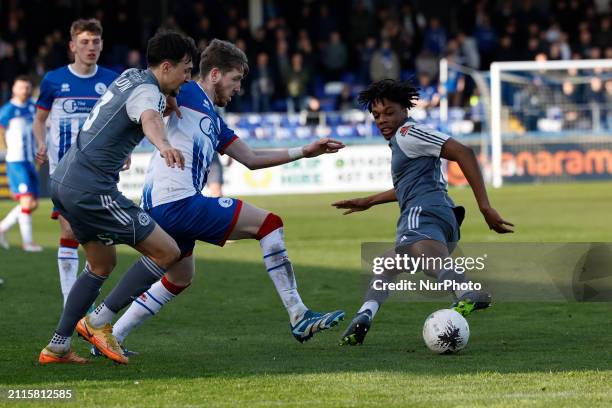 Tom Crawford of Hartlepool United is battling with Ryan Galvin and Kane Thompson-Sommers of FC Halifax Town during the Vanarama National League match...