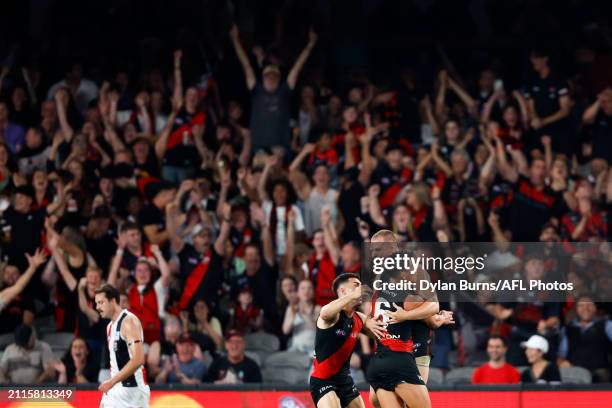 Jake Stringer of the Bombers celebrates a goal with teammates during the 2024 AFL Round 03 match between the Essendon Bombers and the St Kilda Saints...