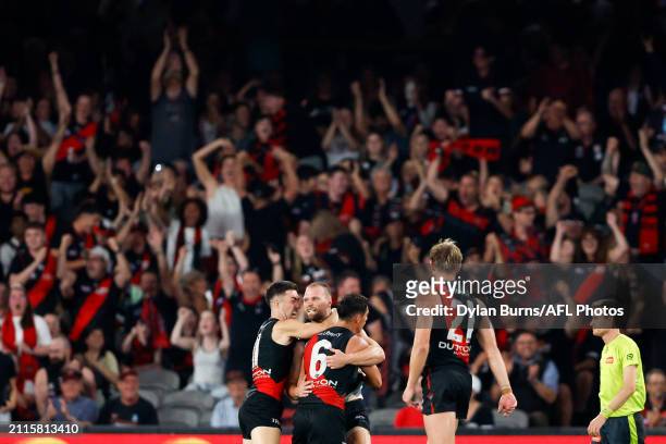 Jake Stringer of the Bombers celebrates a goal with teammates during the 2024 AFL Round 03 match between the Essendon Bombers and the St Kilda Saints...