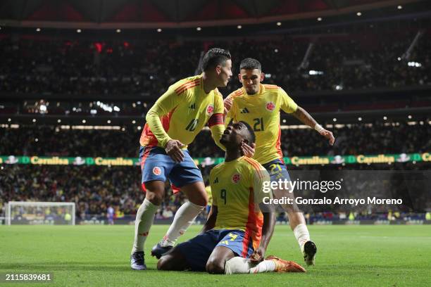 Jhon Cordoba of Colombia celebrates scoring their opening goal with teammates James Rodriguez and Daniel Munoz during the friendly match between...