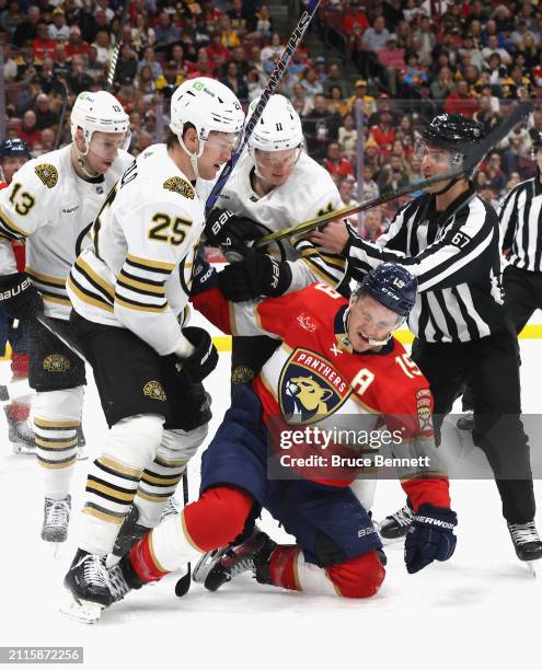 Brandon Carlo of the Boston Bruins hits Matthew Tkachuk of the Florida Panthers during the second period at Amerant Bank Arena on March 26, 2024 in...