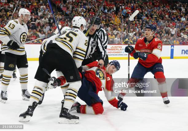 Brandon Carlo of the Boston Bruins hits Matthew Tkachuk of the Florida Panthers during the second period at Amerant Bank Arena on March 26, 2024 in...
