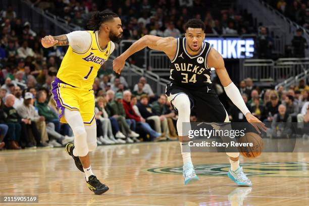 Giannis Antetokounmpo of the Milwaukee Bucks drives around D'Angelo Russell of the Los Angeles Lakers during the first half of a game at Fiserv Forum...