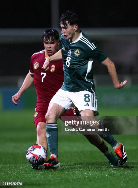 Jack Doherty of Northern Ireland is challenged by Kevin Mondovics of Hungary during the Under-17 EURO Elite Round match between Hungary and Northern...