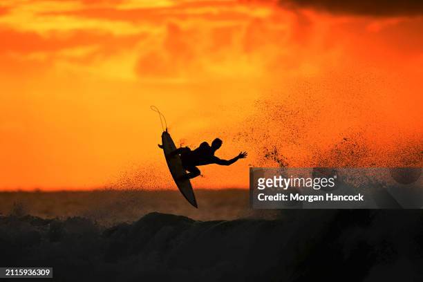 Surfer warms up at sunrise ahead of the 2024 Rip Curl Pro Bells Beach on March 27, 2024 in Winkipop, Australia.