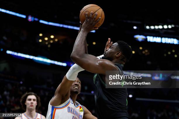 Zion Williamson of the New Orleans Pelicans drives the ball around Jalen Williams of the Oklahoma City Thunder at Smoothie King Center on March 26,...