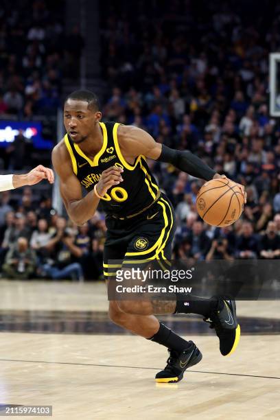 Jonathan Kuminga of the Golden State Warriors dribbles the ball against the Memphis Grizzlies at Chase Center on March 20, 2024 in San Francisco,...