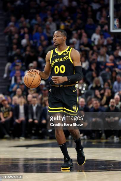 Jonathan Kuminga of the Golden State Warriors dribbles the ball against the Memphis Grizzlies at Chase Center on March 20, 2024 in San Francisco,...
