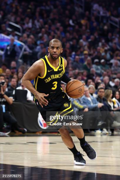 Chris Paul of the Golden State Warriors dribbles the ball against the Memphis Grizzlies at Chase Center on March 20, 2024 in San Francisco,...