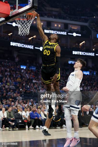 Jonathan Kuminga of the Golden State Warriors goes up for a dunk on Jake LaRavia of the Memphis Grizzlies at Chase Center on March 20, 2024 in San...