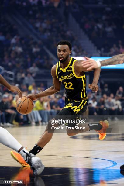 Andrew Wiggins of the Golden State Warriors dribbles the ball against the Memphis Grizzlies at Chase Center on March 20, 2024 in San Francisco,...