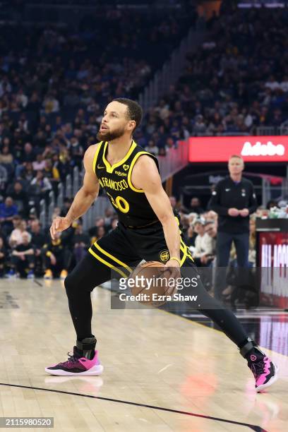 Stephen Curry of the Golden State Warriors dribbles the ball against the Memphis Grizzlies at Chase Center on March 20, 2024 in San Francisco,...