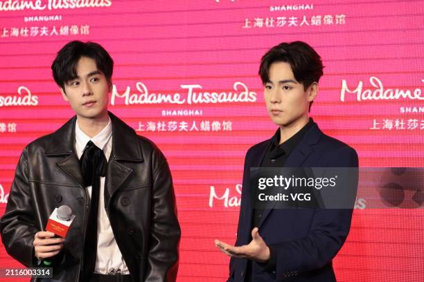 Actor Hu Yitian poses with his wax figure during the unveiling ceremony at Madame Tussauds Shanghai on March 26, 2024 in Shanghai, China.