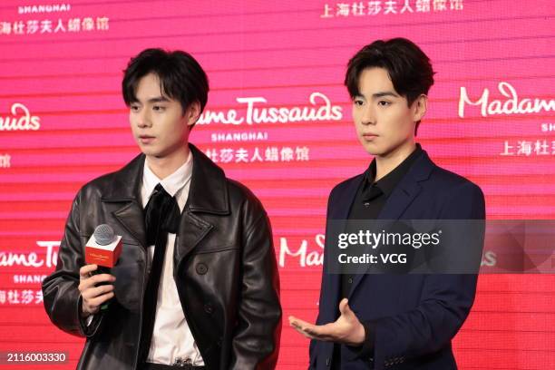 Actor Hu Yitian poses with his wax figure during the unveiling ceremony at Madame Tussauds Shanghai on March 26, 2024 in Shanghai, China.