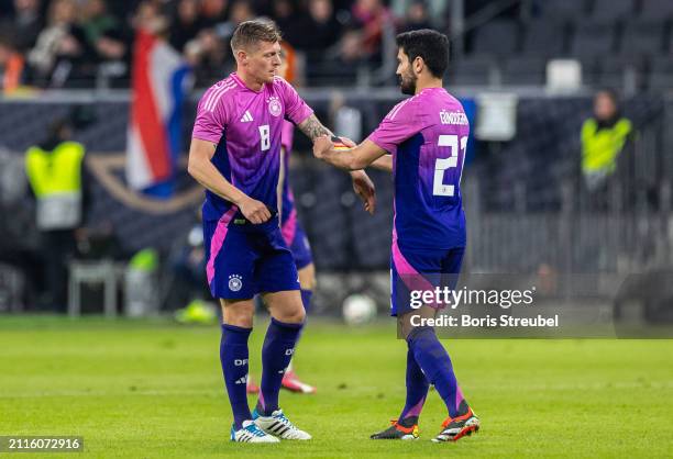 Ilkay Guendogan of Germany gives the captains armband to Toni Kroos of Germany during the international friendly match between Germany and...