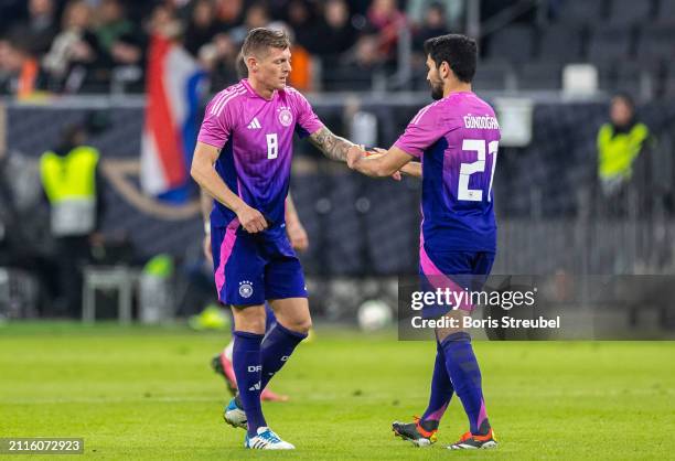 Ilkay Guendogan of Germany gives the captains armband to Toni Kroos of Germany during the international friendly match between Germany and...