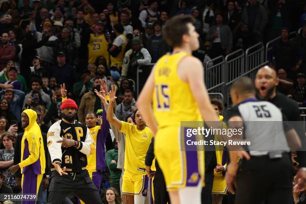 LeBron James of the Los Angeles Lakers reacts to a three point shot by Austin Reaves during the second overtime of the game against the Milwaukee...