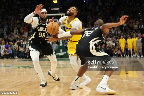 Angelo Russell of the Los Angeles Lakers is fouled by Khris Middleton of the Milwaukee Bucks during overtime at Fiserv Forum on March 26, 2024 in...