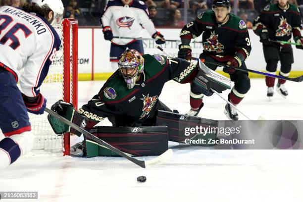 Karel Vejmelka of the Arizona Coyotes makes a save against Kirill Marchenko of the Columbus Blue Jackets during the first period at Mullett Arena on...