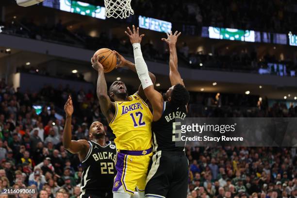 Taurean Prince of the Los Angeles Lakers is defended by Malik Beasley of the Milwaukee Bucks during the second half of a game at Fiserv Forum on...