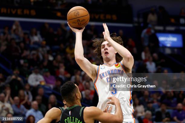 Josh Giddey of the Oklahoma City Thunder shoots the ball over CJ McCollum of the New Orleans Pelicans at Smoothie King Center on March 26, 2024 in...