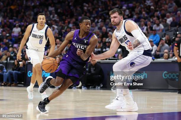 De'Aaron Fox of the Sacramento Kings is guarded by Luka Doncic of the Dallas Mavericks in the first half at Golden 1 Center on March 26, 2024 in...
