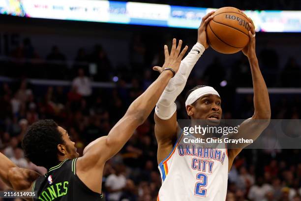 Shai Gilgeous-Alexander of the Oklahoma City Thunder shoots the ball over Herb Jones of the New Orleans Pelicans at Smoothie King Center on March 26,...