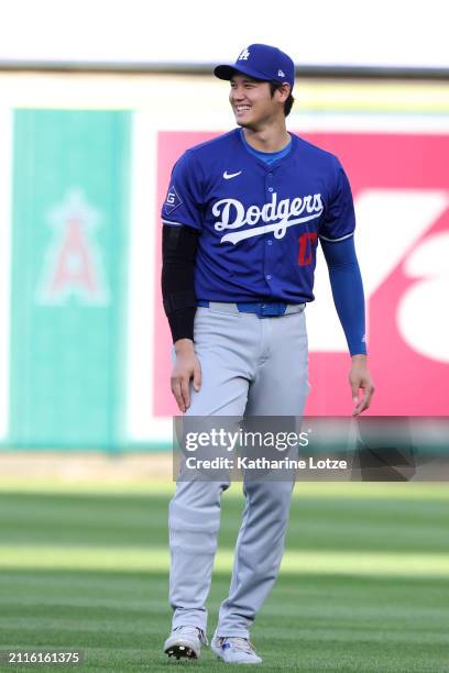 Shohei Ohtani of the Los Angeles Dodgers smiles ahead of an exhibition game against the Los Angeles Angels at Angel Stadium of Anaheim on March 26,...