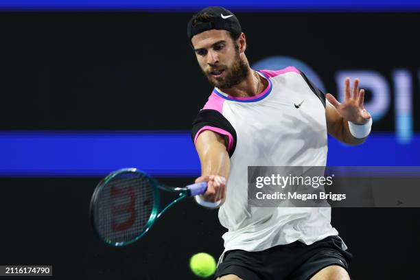 Karen Khachanov returns a shot to Alexander Zverev of Germany during his men's singles round of 16 match during the Miami Open at Hard Rock Stadium...