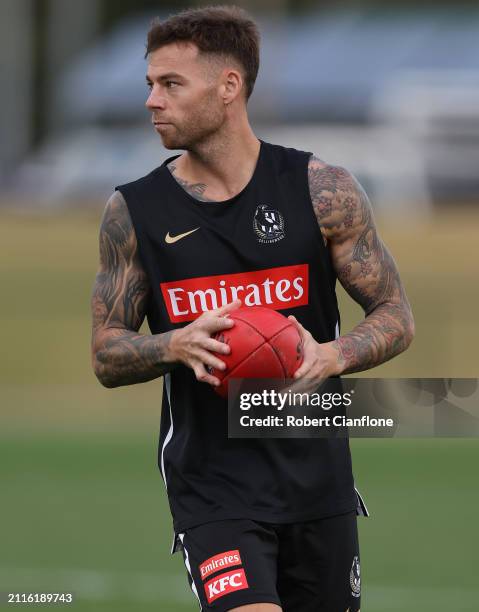 Jamie Elliott of the Magpies looks on during a Collingwood Magpies AFL training session at Olympic Park Oval on March 27, 2024 in Melbourne,...