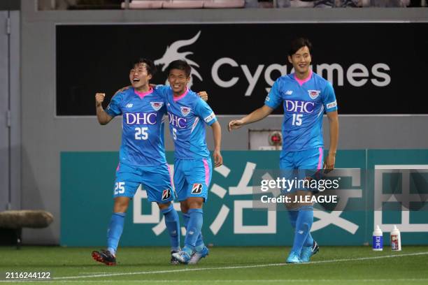 An Yong-woo of Sagan Tosu celebrates with teammates Akito Fukuta and Jung Seung-hyun after scoring the team's first goal during the J.League J1 match...