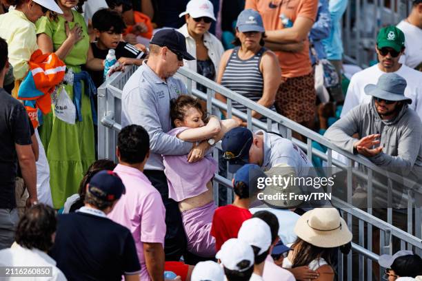 Fan is carried out of Grandstand during the match between Alex Sinner of Italy and Christopher O'Connell of Australia after passing out after a...