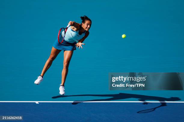 Caroline Garcia of France serves against Naomi Osaka of Japan in the third round of the Miami Open at the Hard Rock Stadium on March 24, 2024 in...