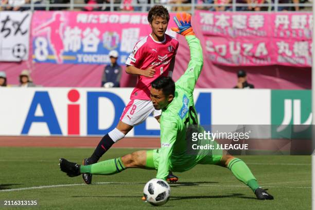 Yoichiro Kakitani of Cerezo Osaka scores the team's first goal past Kenta Tokushige of V-Varen Nagasaki during the J.League J1 match between Cerezo...