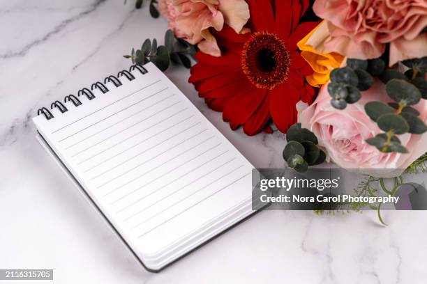 blank notepad and flower bouquet - spiral notebook stock pictures, royalty-free photos & images