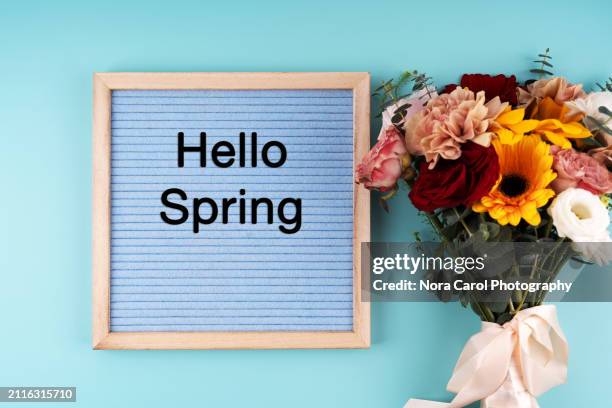 mixed flower bouquet and a letter board with text hello spring - table font view stock pictures, royalty-free photos & images