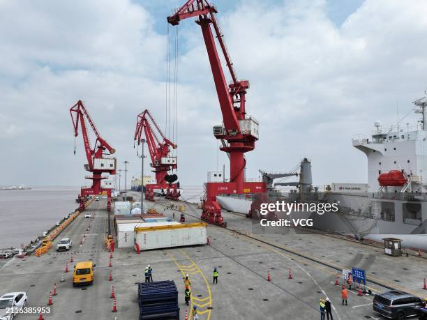 Staff members unload imported kiwifruit from a refrigerated cargo ship at Nangang Port on March 26, 2024 in Shanghai, China. The first batch of this...