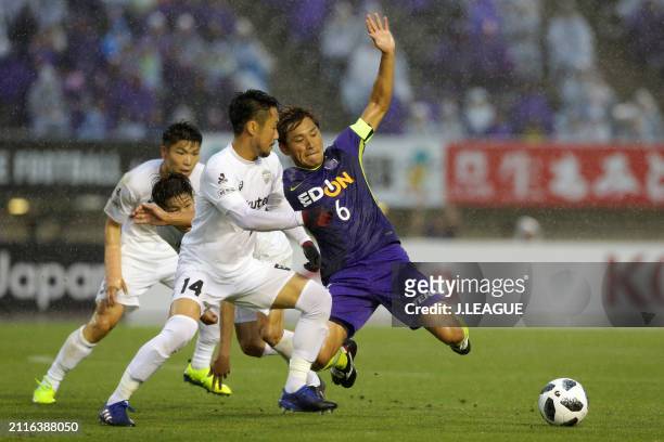 Toshihiro Aoyama of Sanfrecce Hiroshima and Naoyuki Fujita of Vissel Kobe compete for the ball during the J.League J1 match between Sanfrecce...