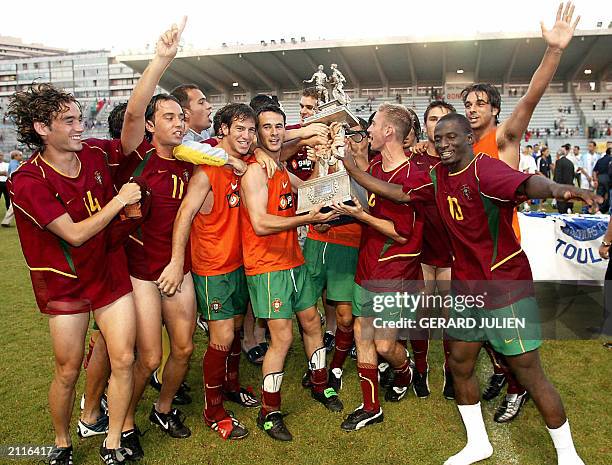 Portugal's soccer players hold their trophy after they won the final match of the International Under-21 soccer tournament against Italy, 21 June...