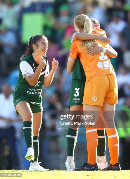 Emma Ilijoski, Sarah Clark and Chloe Lincoln of Canberra United celebrate winning the A-League Women round 17 match between Canberra United and...