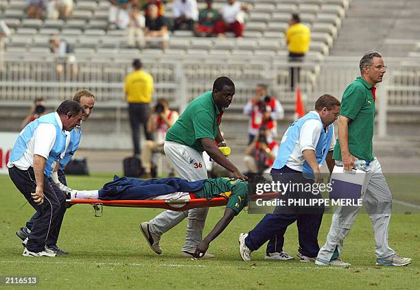 Cameroonian midfielder Marc-Vivien Foe is carried off the field on a stretcher during the semi-final soccer Confederations Cup match between Colombia...