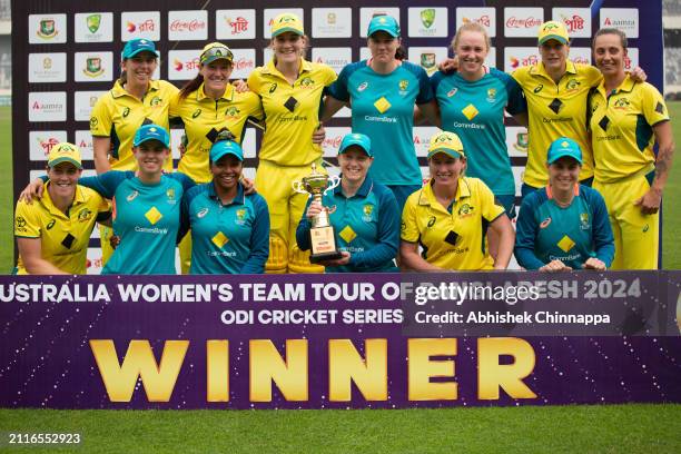 Australia players pose with the winner's trophy after game three of the Women's One Day International series between Bangladesh and Australia at...