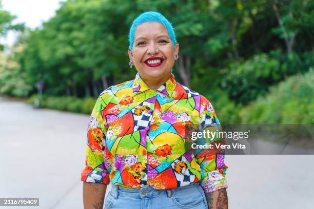 front portrait of homosexual hispanic person outdoors with happy expression - blue hair stock pictures, royalty-free photos & images