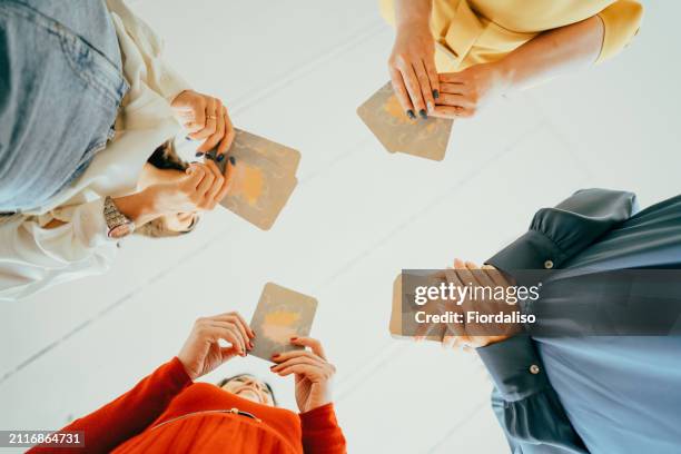 four women are playing metaphorical card - spirituality stock pictures, royalty-free photos & images